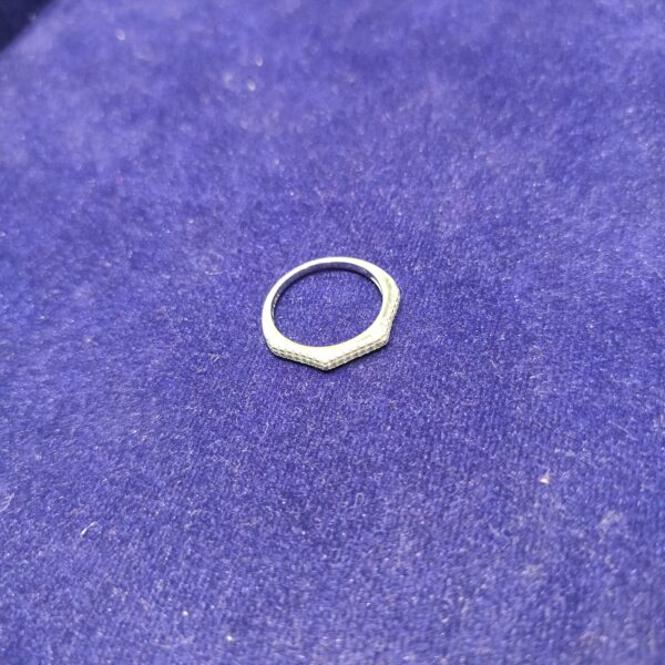 Silver ring on purple background